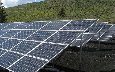 Wind turbines are installed at the top of each mountain, as well as iron frames for electrical wires